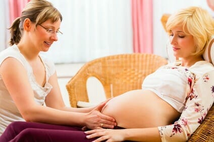 Midwife seeing mother for pregnancy examination Midwife seeing mother for pregnancy examination